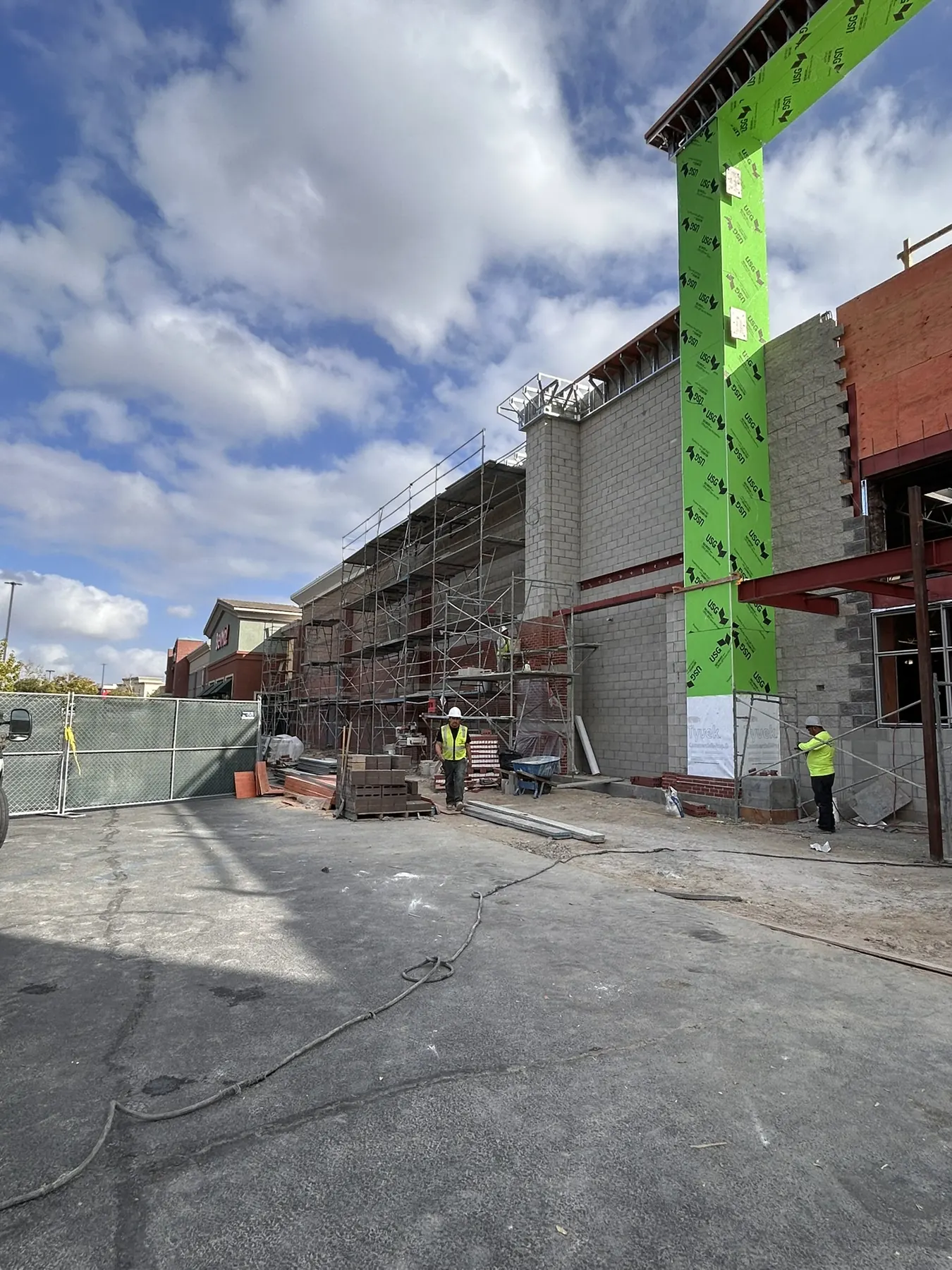 Masonry crew building concrete block walls on a commercial construction site