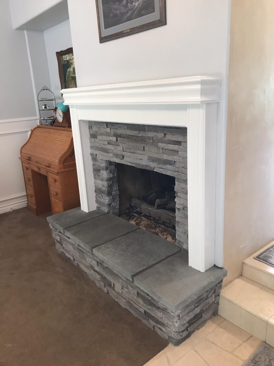 Precast mantel over a stacked stone hearth
