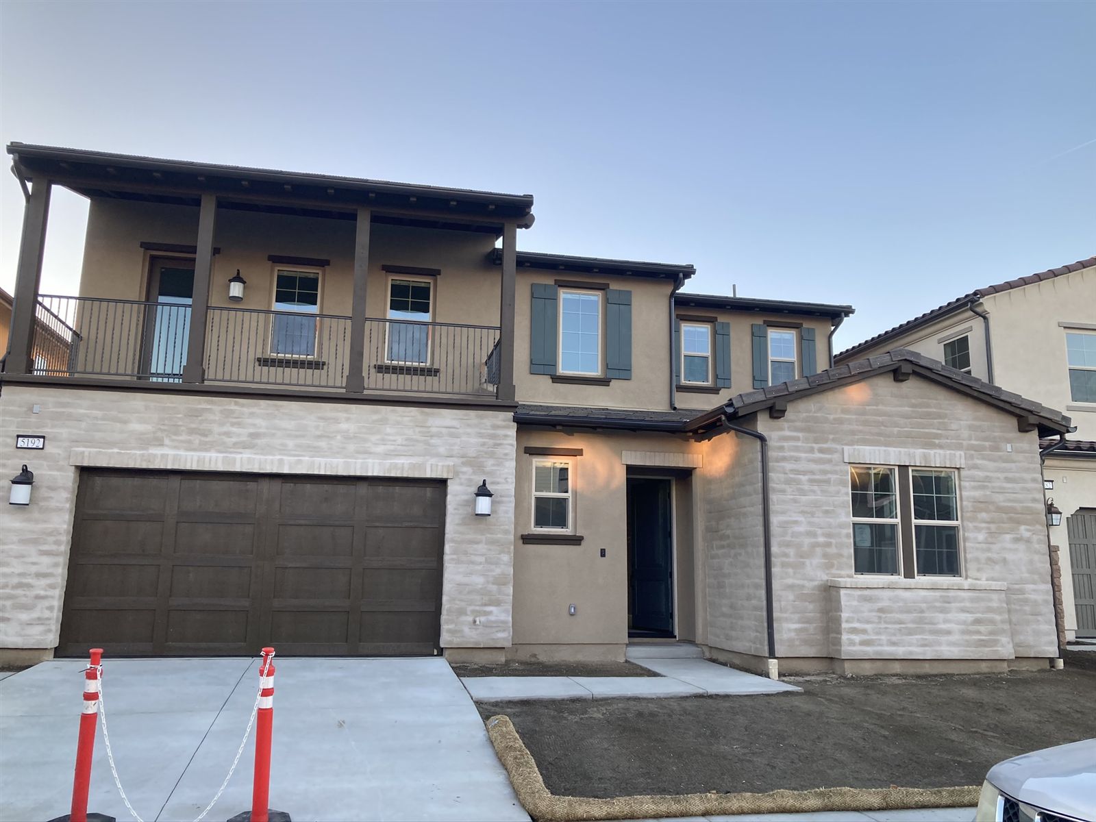 Two-story stone & stucco by CMF Masonry